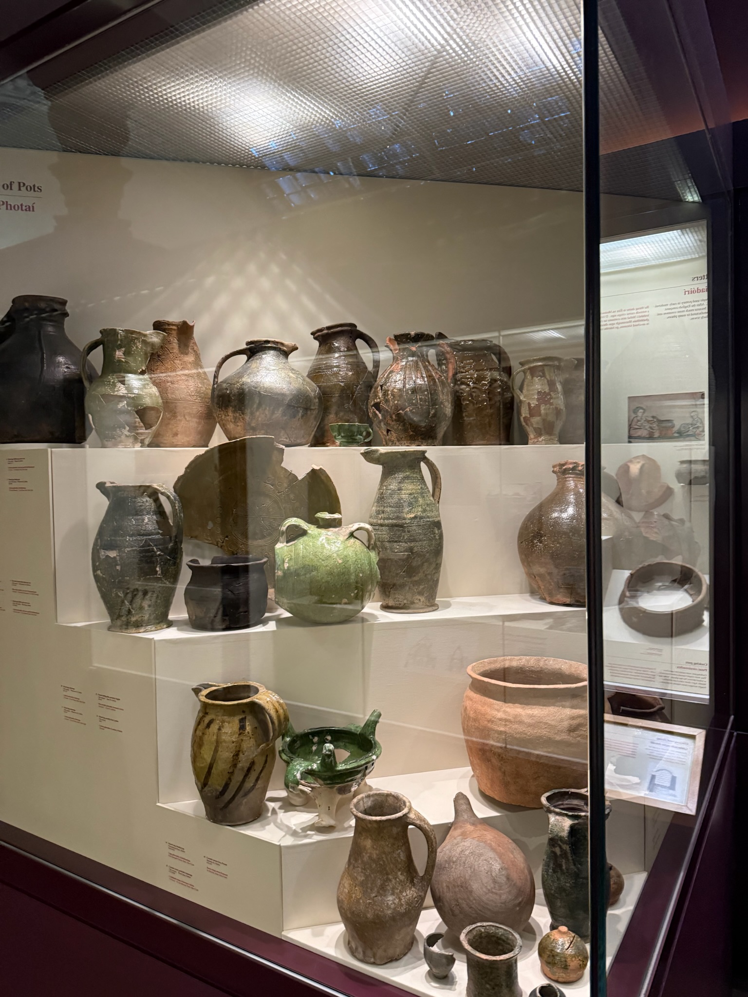Old clay jars, pitchers, and pots that are painted in earth toned colors