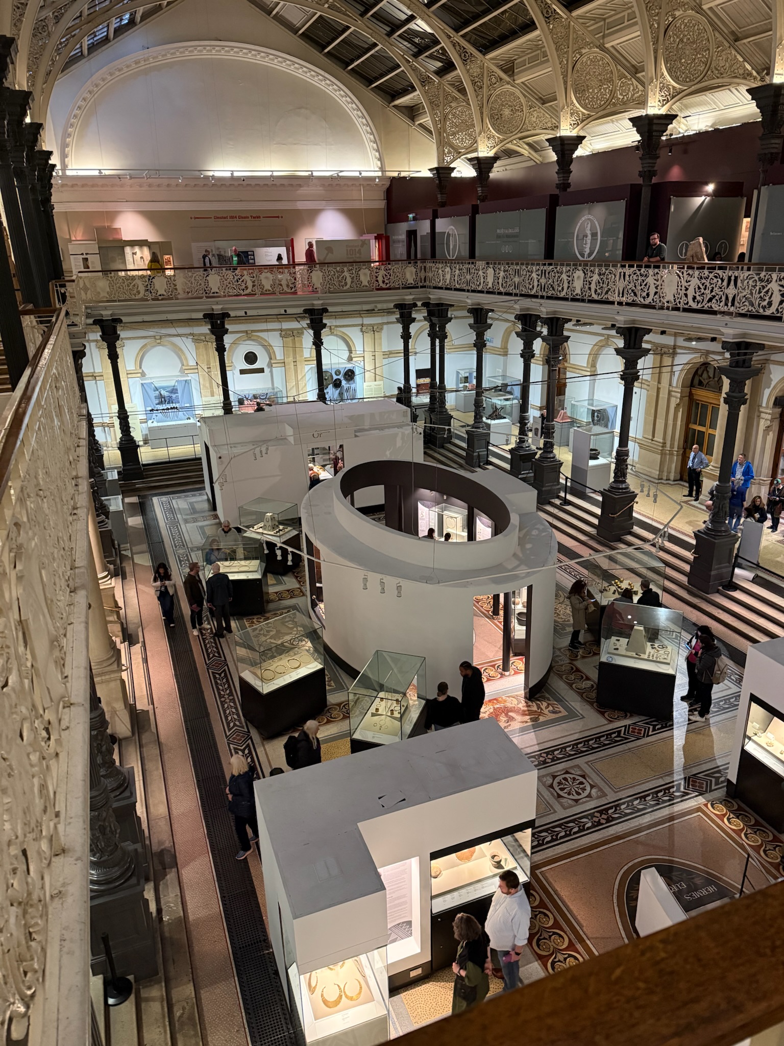 The view from the second floor of the museum, looking down, you can see the various display cases and the colorful, tiled floors